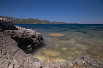 Fototapeta na wymiar Long exposure of a rocky beach on the Mediterranean Sea, in Corsica