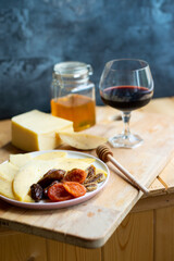 cheese snack with honey fruit and red wine