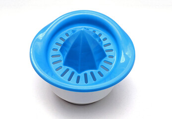 Plastic juice squeezer on white