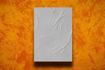 White crumpled paper on a orange background.