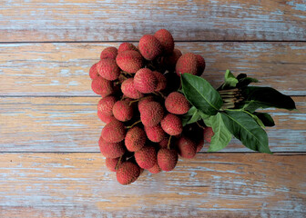 Lychee on wooden background for sale in local market.background, farmer fruit market.