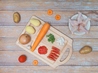 Ingredients for soup with chicken and potato ,carrot ,tomato ,onion.