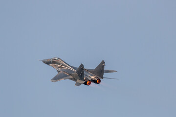 Air force jet fighter showing afterburner flames during aerobatic display