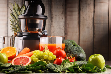 Slow juicer with organic fruits and vegetables.