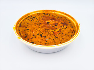 Indian food in takeout container, Chicken tikka masala in takeaway plastic bowl on white background for eat at home, Delivery food.