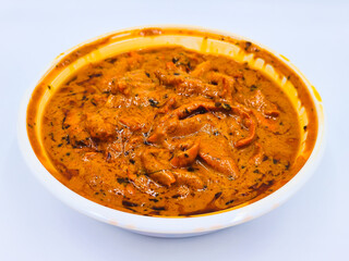 Indian food in takeout container, Chicken tikka masala in takeaway plastic bowl on white background for eat at home, Delivery food.