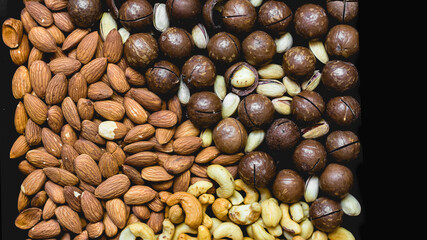 healthy food background assorted macadamia nuts, almonds, cashews, pistachios