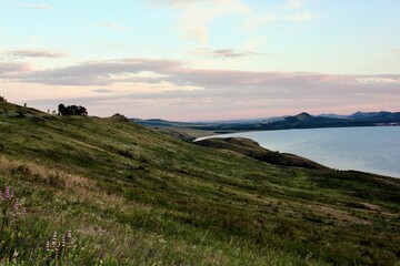 Magical panoramic landscape with a mountain lake in the mountains at sunset. Relaxation, harmony, antistress - concept. Sunset
