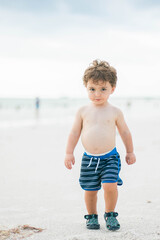 little boy on the beach in Marco island beach walking on the sand 