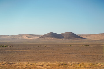 Fototapeta na wymiar bleak desert landscape with mountain and rock formations
