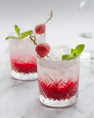 Strawberry Cold Cocktail. Fresh summer cocktail with strawberry, mint and ice. Glass of strawberry soda drink.