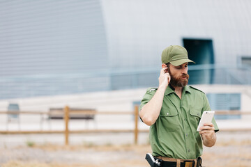 security guard in uniform and armed working on the safety of buildings