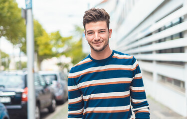 Handsome young man walking through street