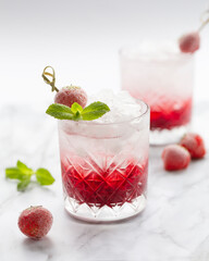 Strawberry Cold Cocktail. Fresh summer cocktail with strawberry, mint and ice. Glass of strawberry soda drink.