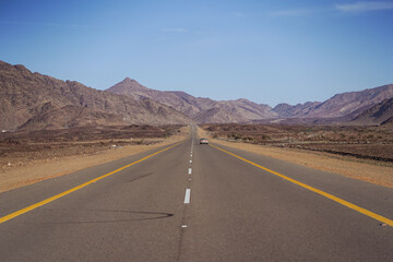 Fototapeta na wymiar beautiful straight highway surrounded by rock mountains