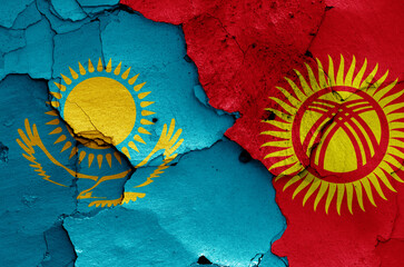 flags of Kazakhstan and Kyrgyzstan painted on cracked wall