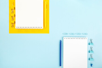 School office supplies on blue and yellow background. Back to school concept. Geometric and monochrome composition. Top view. Copy space