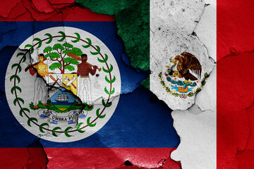 flags of Belize and Mexico painted on cracked wall