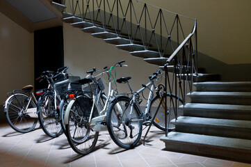 Bikes parked in the basement of an Italian house with stairs