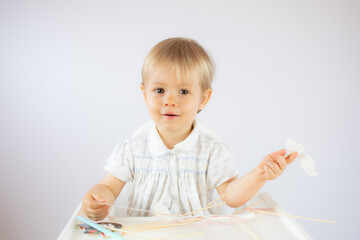 Blond baby playing with objects