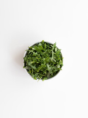 Fototapeta na wymiar bowl of arugula salad, fresh and healthy greens, top view