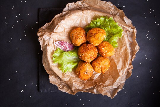 Fried Chicken Balls With Lettuce And Slices Of Sausage