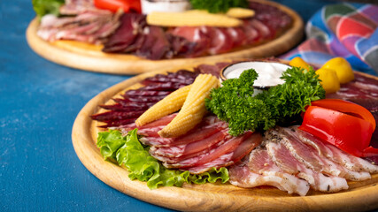 Various of meat on a wooden board.