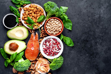 Omega-3 food sources. Foods high in fatty acids, including seafood, vegetables, nuts and seeds on a stone background