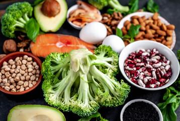 Omega-3 food sources. Foods high in fatty acids, including seafood, vegetables, nuts and seeds on a stone background