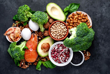 Omega-3 food sources. Foods high in fatty acids, including seafood, vegetables, nuts and seeds on a stone background