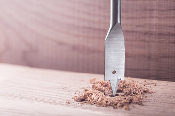 metal drill bit paddle make holes in a wooden oaks plank