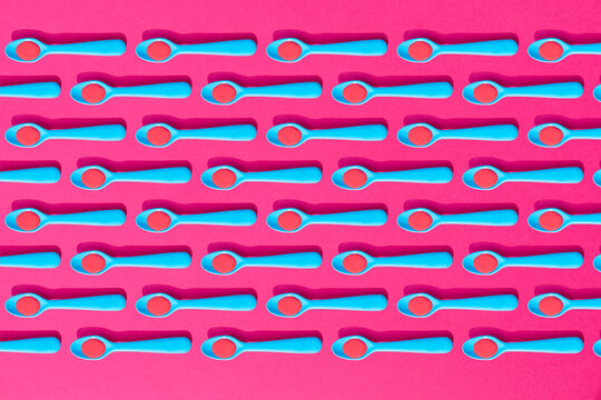 Seamless pattern of?blue plastic teaspoons with red liquid