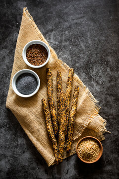 Place mat and fresh Italian?grissini?breadsticks?with sesame, flax and poppy seeds