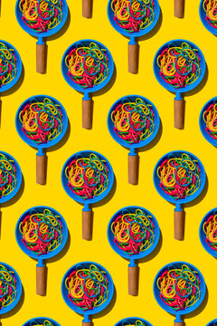 Pattern of toy frying pans with colorful pasta