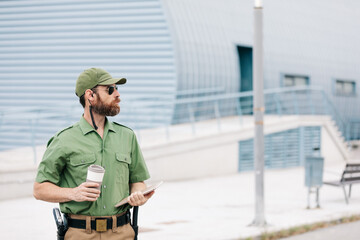 security guard in uniform and armed working on the safety of buildings