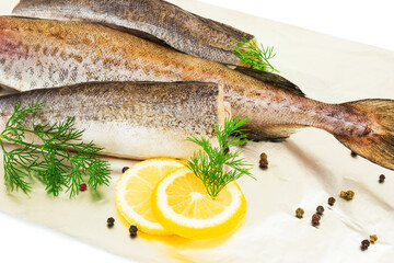 Raw fish hake, pollock on foil with lemon, black pepper and dill