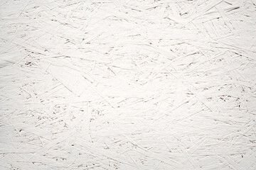 A white panel of pressed wood chips. Textural background.
