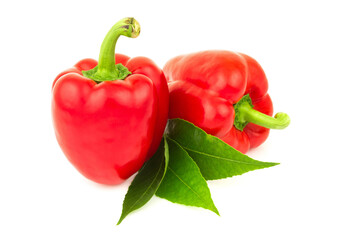 Group of two ripe tasty red, orange sweet bell peppers, paprica with green leaves isolated on white...