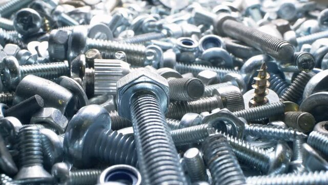 super close. nut and bolt parts, fasteners in a heap