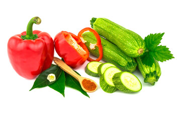 Ripe juicy red sweet bell peppers, paprika, green zucchini with flower, spice on wooden spoon and leaves. Isolated on white background