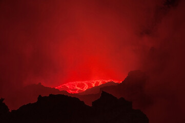 Breathtaking view over amazing red lava lake boiling in crater of active Erta Ale volcano at...