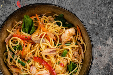 Asian lunch. Buckwheat noodles with seafood, closeup