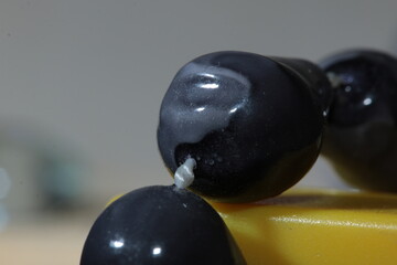 Cheap Dark Grey Plastic Beads, on a white thread,, close up Macro
