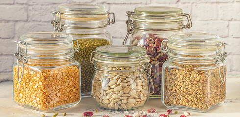 Glass jars with various legumes - beans, mung bean, peas and len