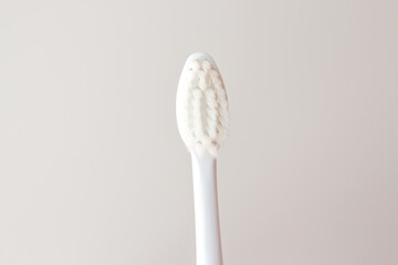 Soft toothbrush for gentle brushing on a beautiful white background close-up. Oral care layout with copy space
