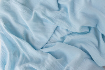 Obraz premium Flat lay modern abstract background blue fabric. Natural blue texture in beautiful folds. Blogger concept, Top view