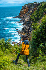 Monte Ulia in the city of San Sebastián, Basque Country. Visit the hidden cove of the city called Illurgita Senadia or Illurgita Senotia. A young woman arriving at the cove of mount ulia