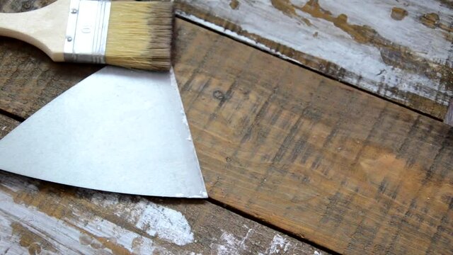 Hands of an old manual worker with wall plastering tools renovating house. Plasterer renovating outdoor walls and corners with spatula and plaster. Wall insulation. Construction finishing works - Imag