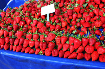 Red ripe strawberries. Lot of ripe red strawberries are on sale. Showcase of the retail market of...