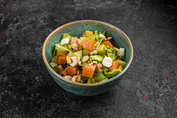 chinese salad in black bowl in restaurant